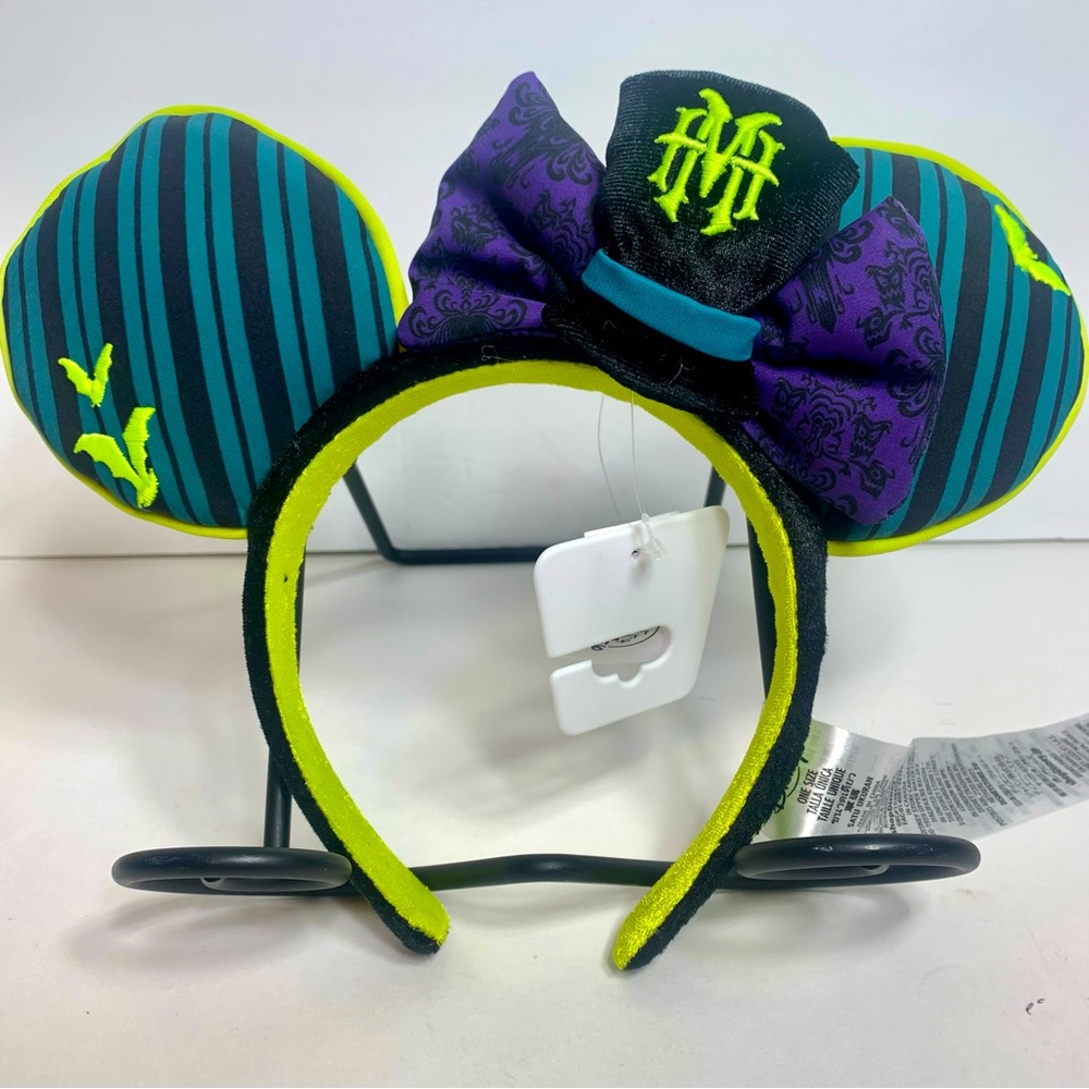 NWT. Disney Haunted Mansion Minnie ears with glow in dark piping.